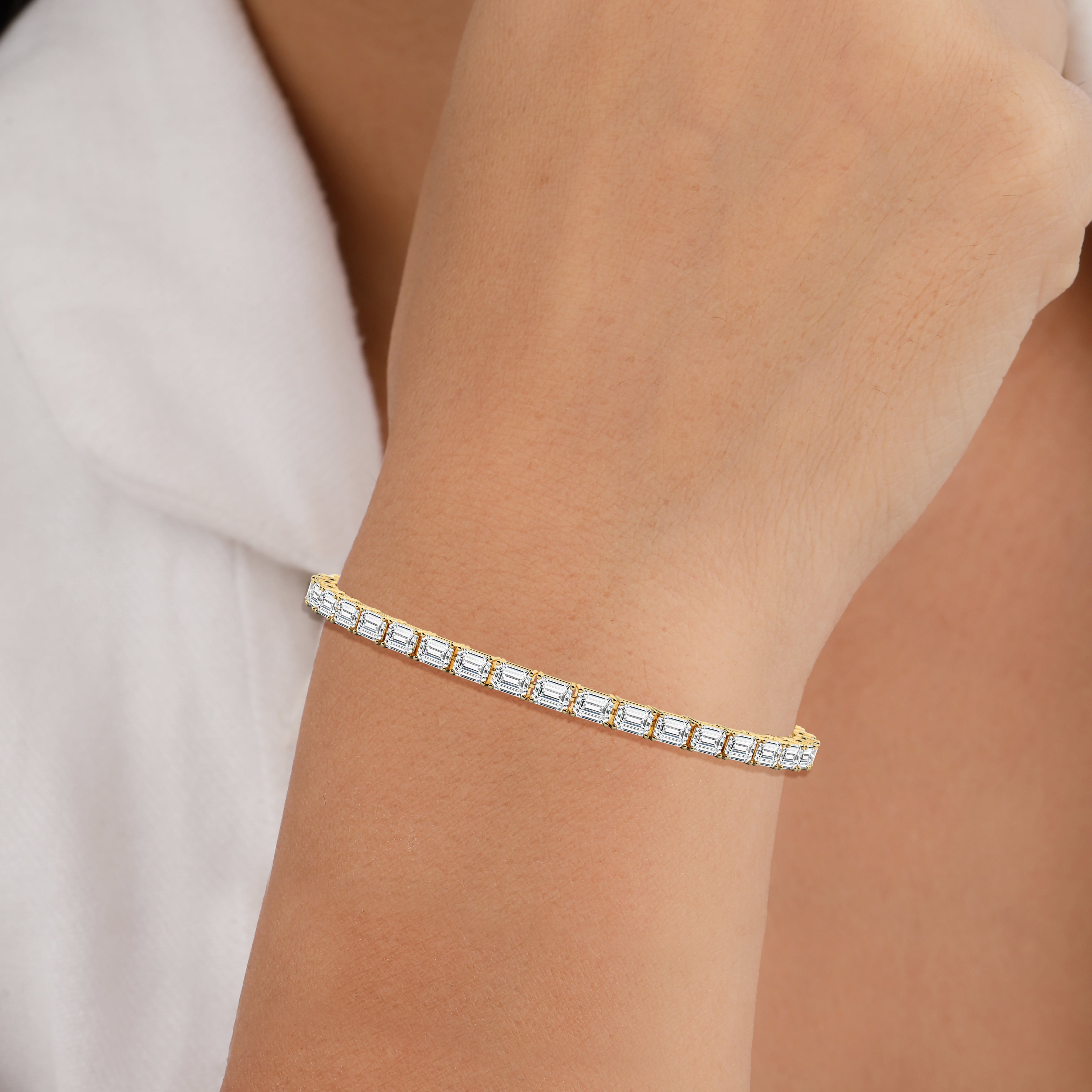 emerald shape east west diamond tennis bracelet