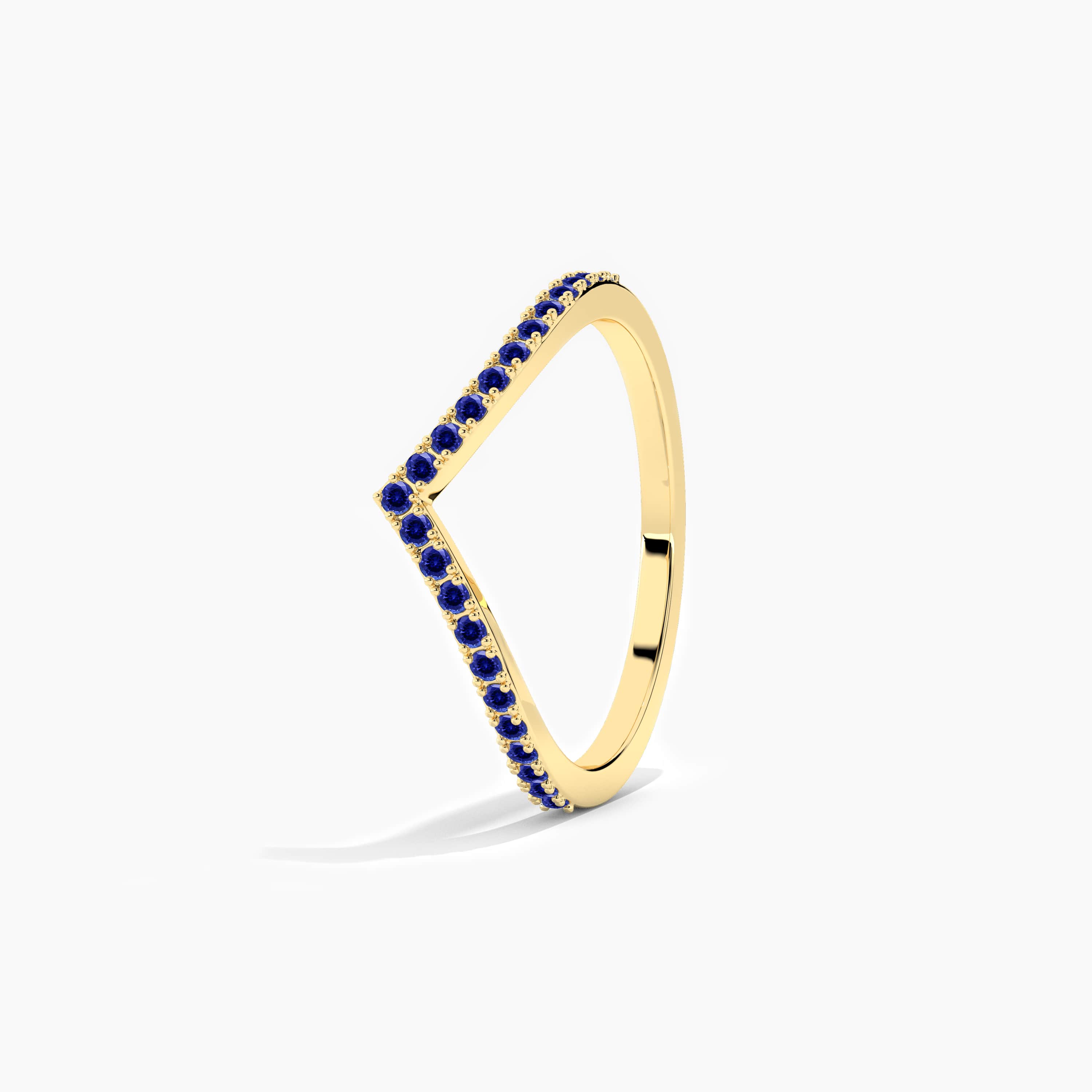 yellow gold curved ring in blue sapphire