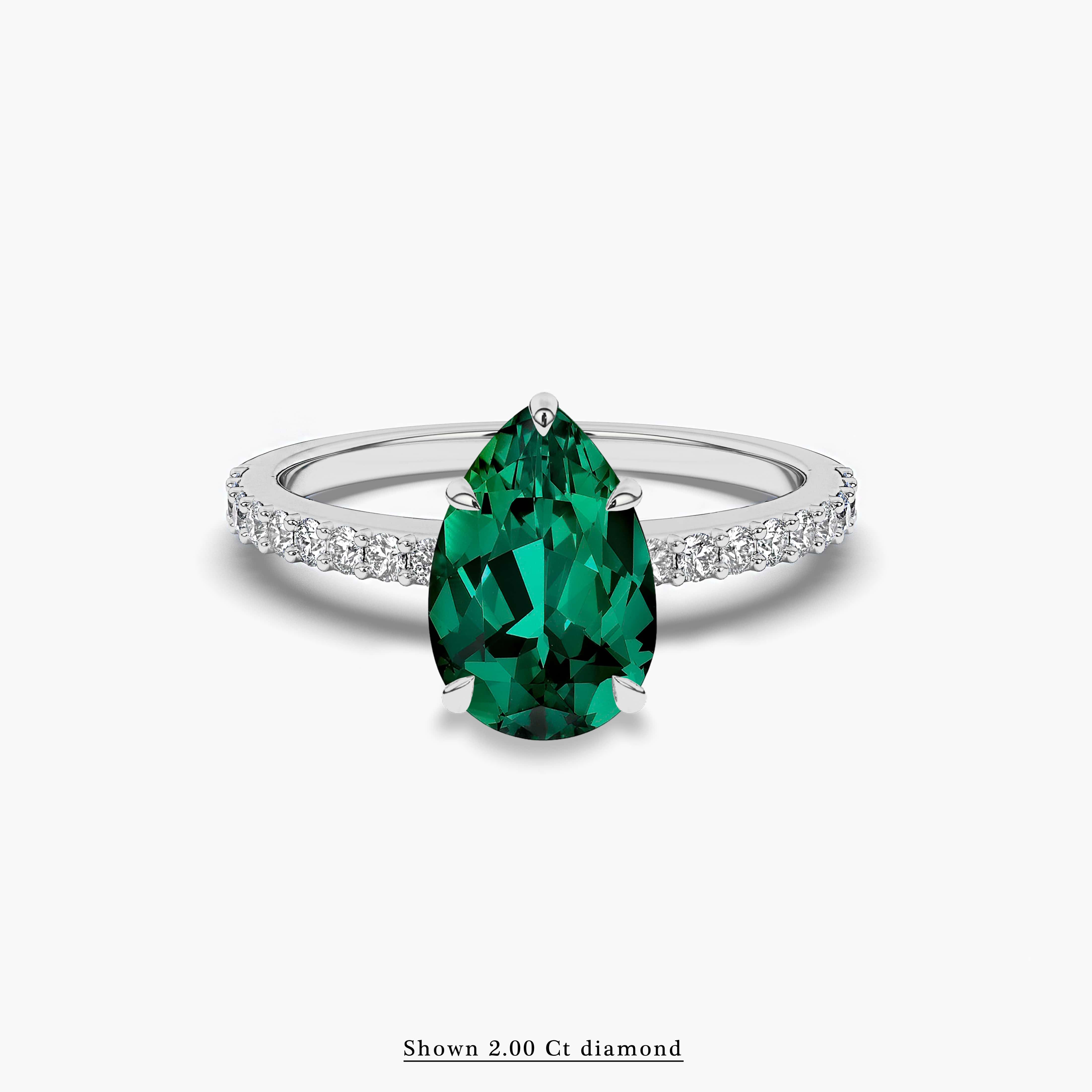 green emerald and diamond side stones engagement ring