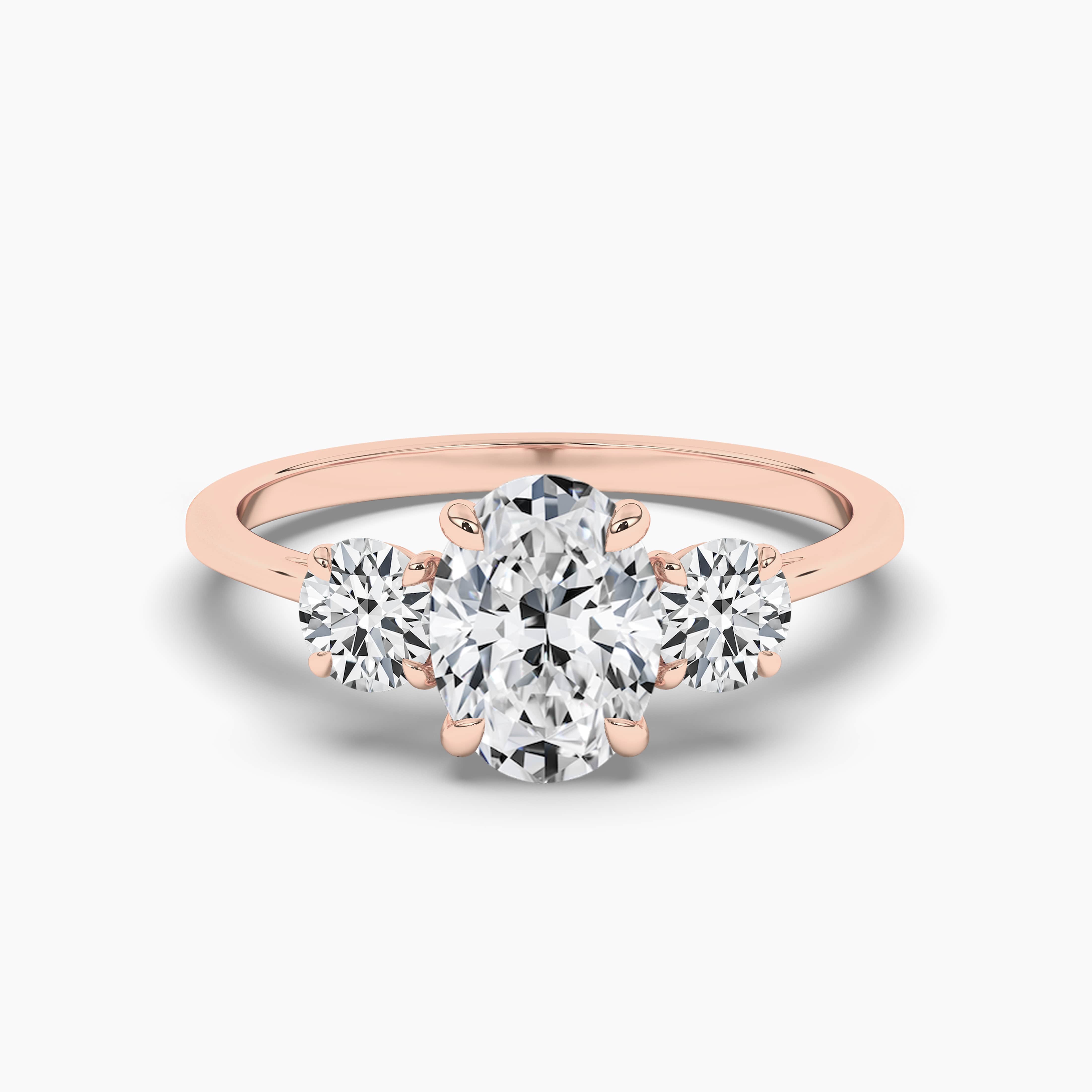 OVAL CUT DIAMOND ENGAGEMENT RING WITH A THREE STONE  IN  ROSE GOLD