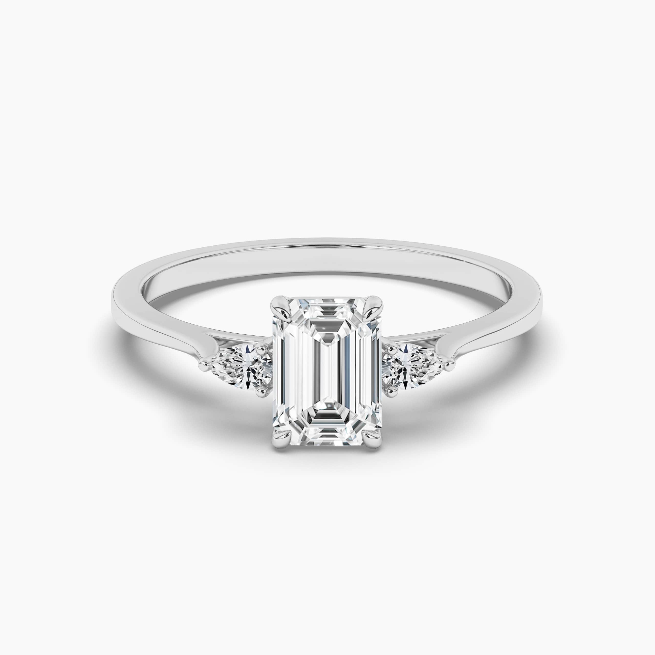 Three Stone Engagement Ring With Pear Side Stones and Emerald Cut