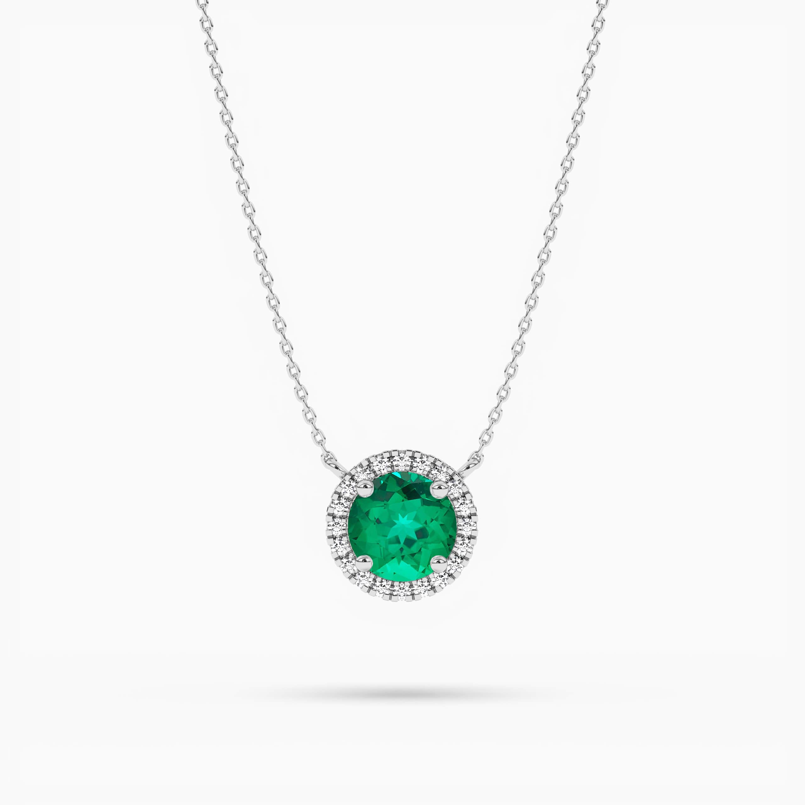 Emerald And Diamond Halo Pendant In White Gold