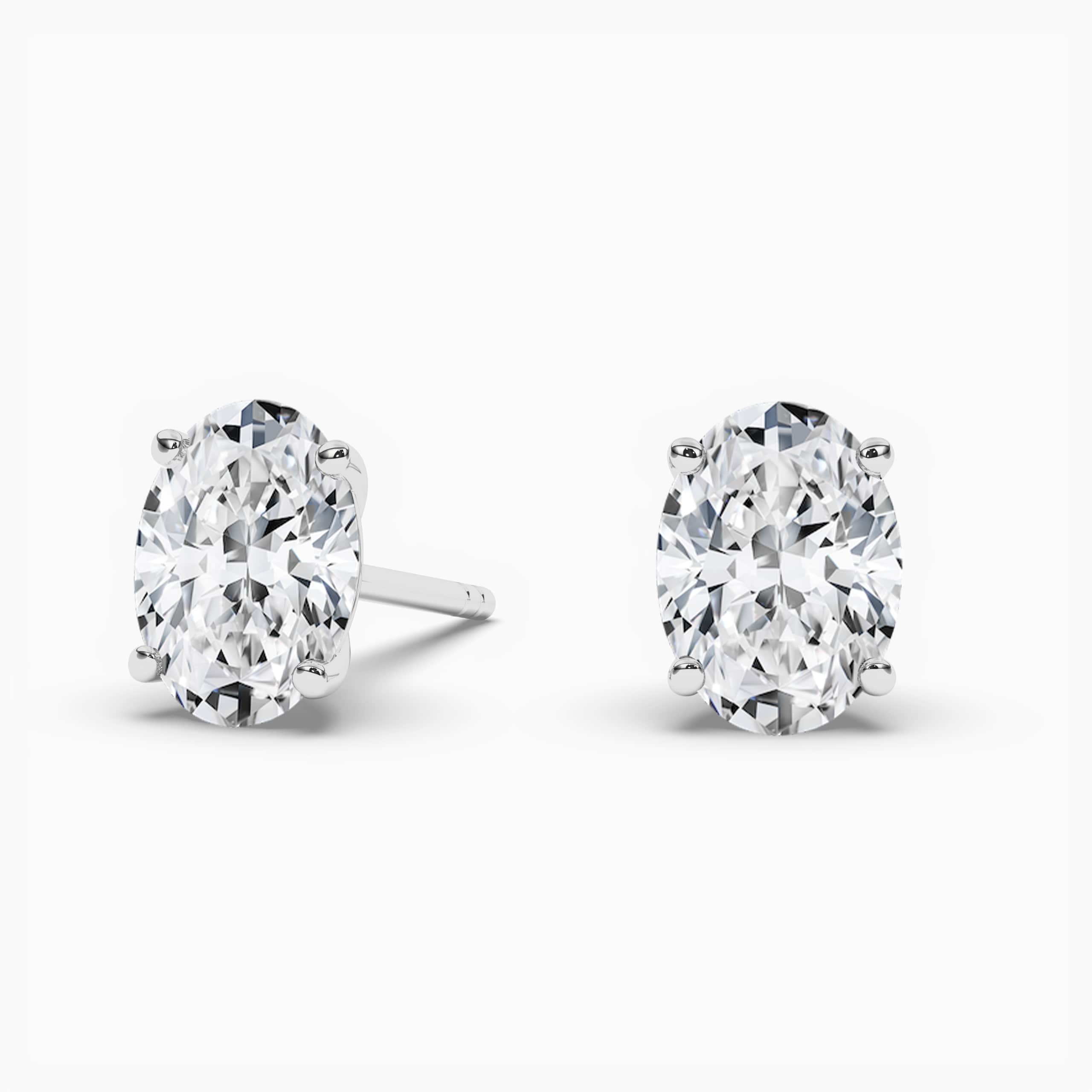 Oval Cut Diamond Solitaire Stud Earrings In White Gold