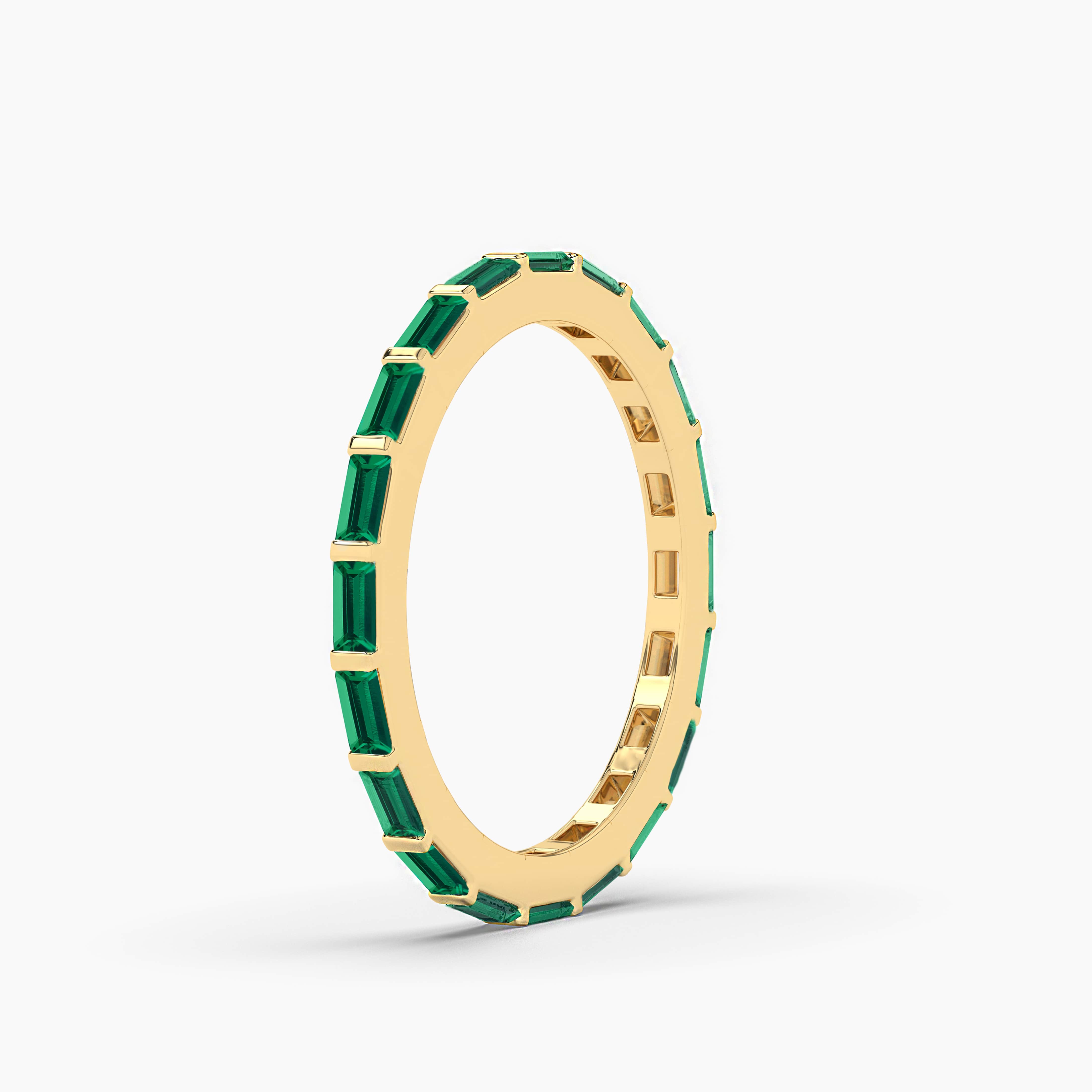 emerald gemstone baguette wedding band in yellow gold