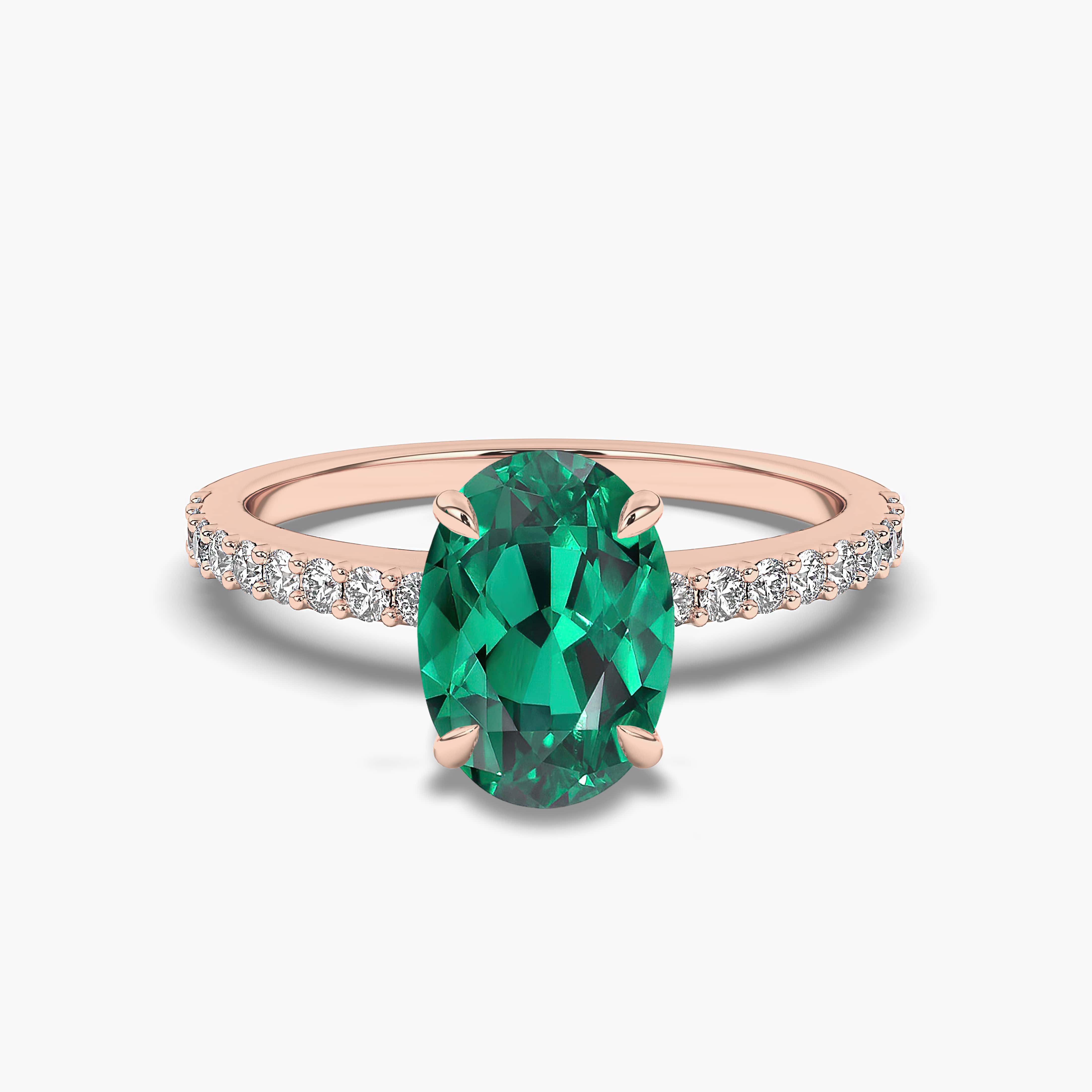 Oval Cut Emerald Side Stone Moissanite Engagement Ring In Rose Gold