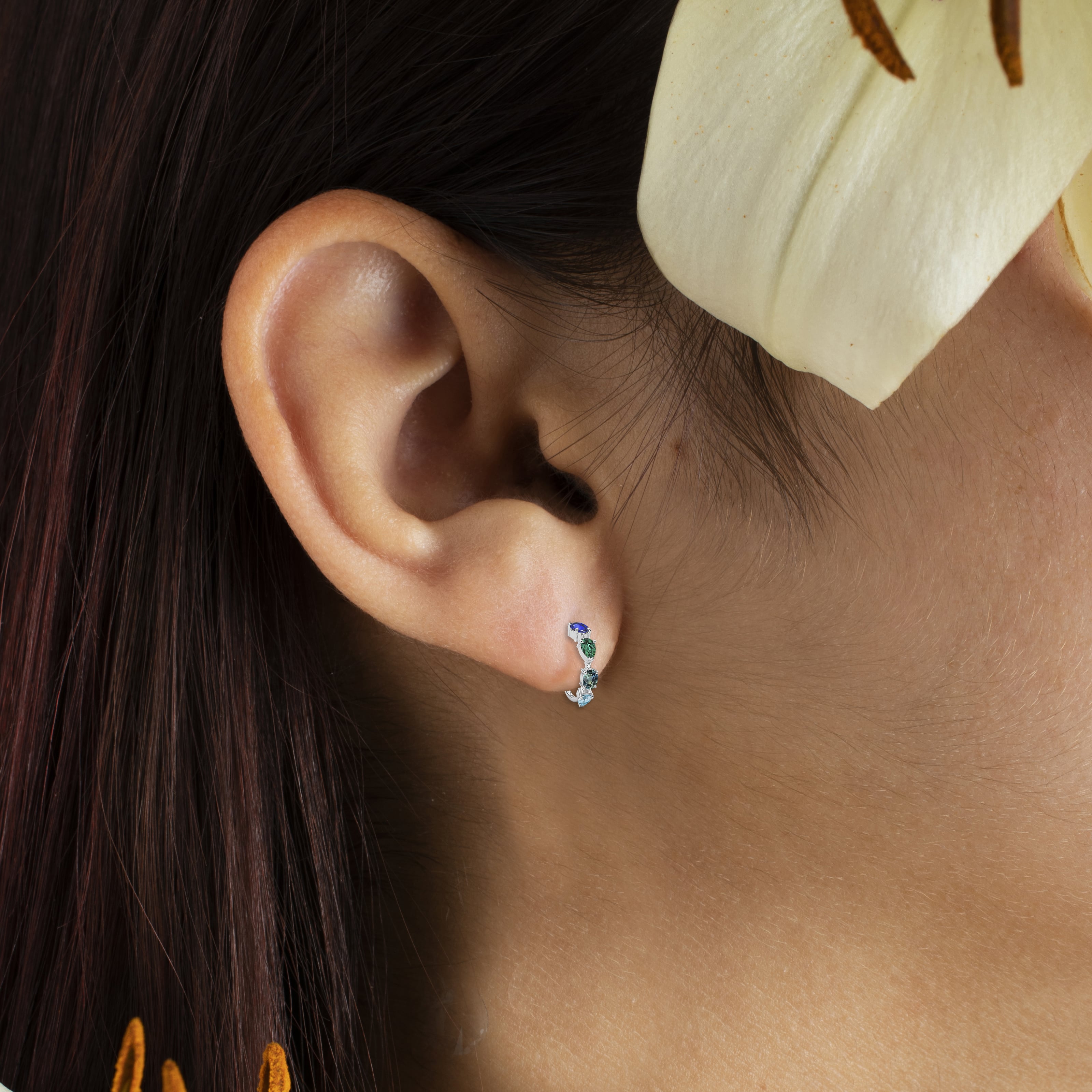 gemstone earrings on ear model