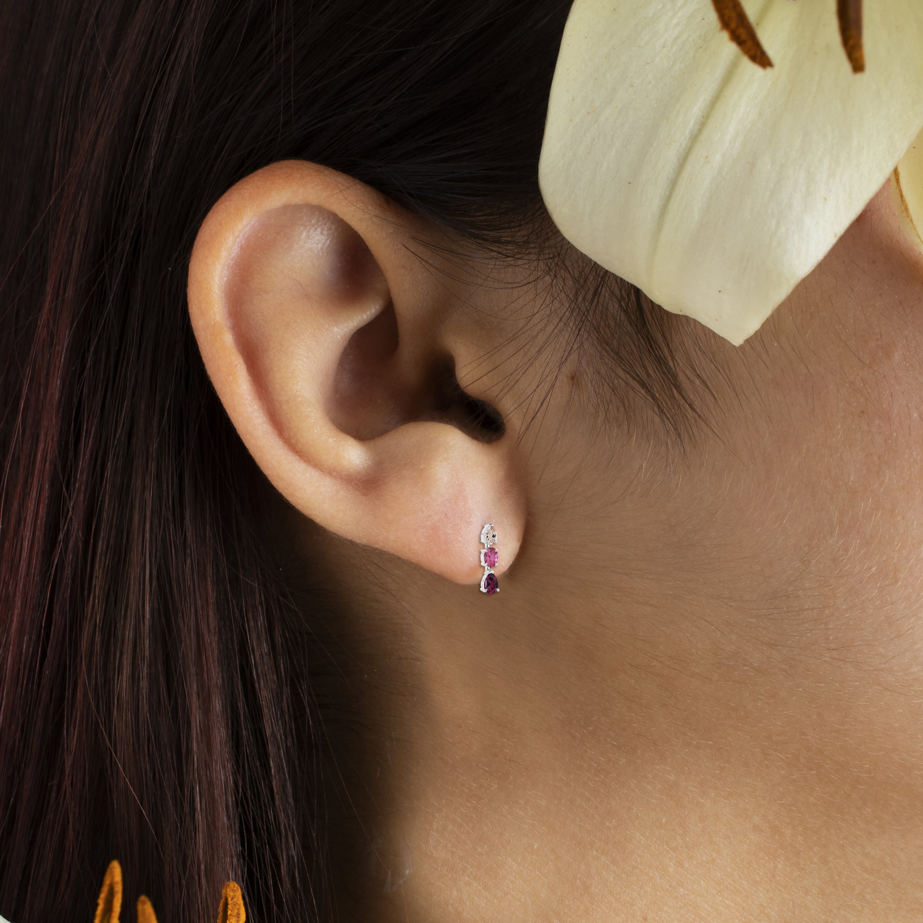 gemstone dangling earrings on model ear