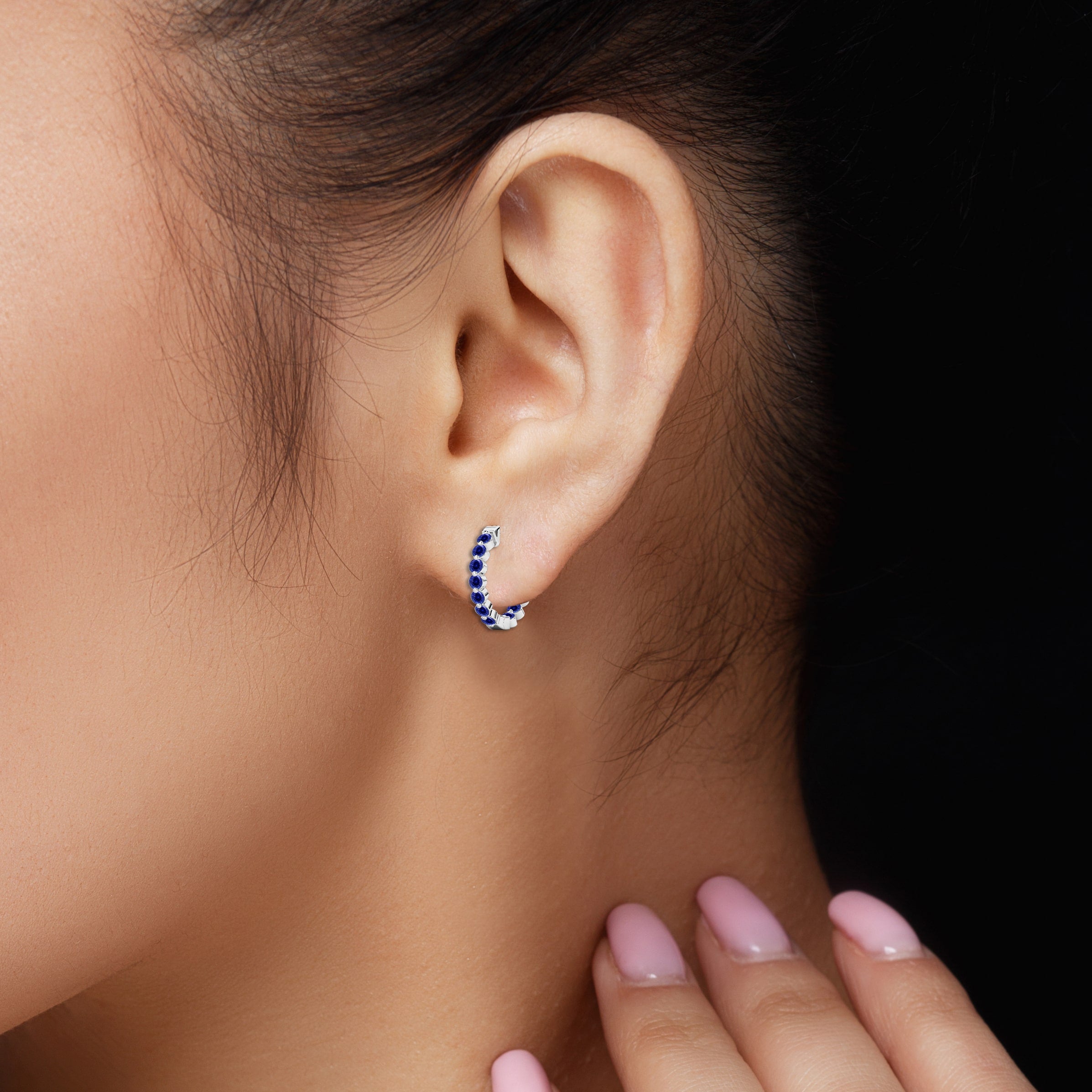 blue sapphire hoop earrings on model ear