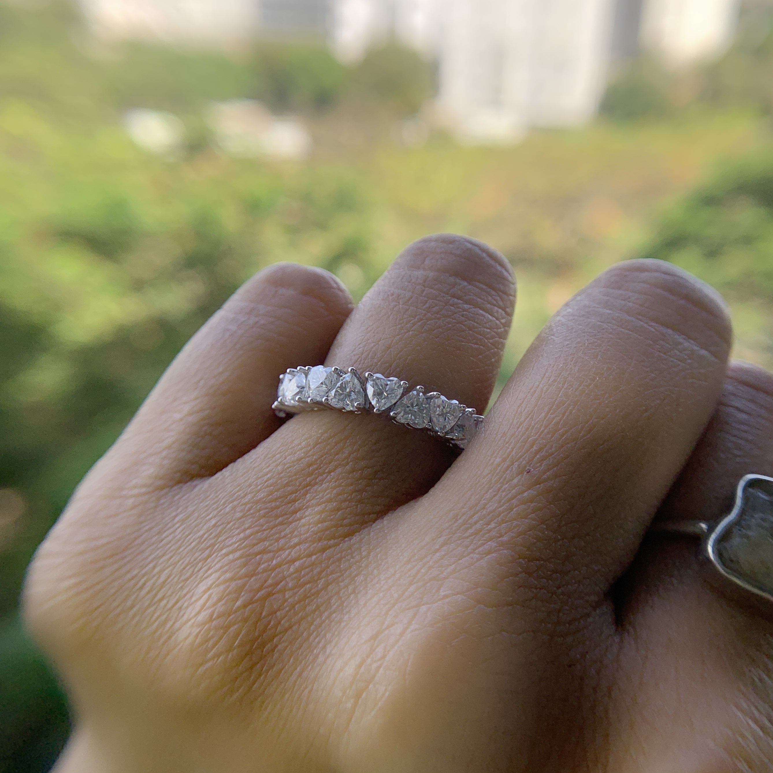 a women is wearing heart shape wedding band