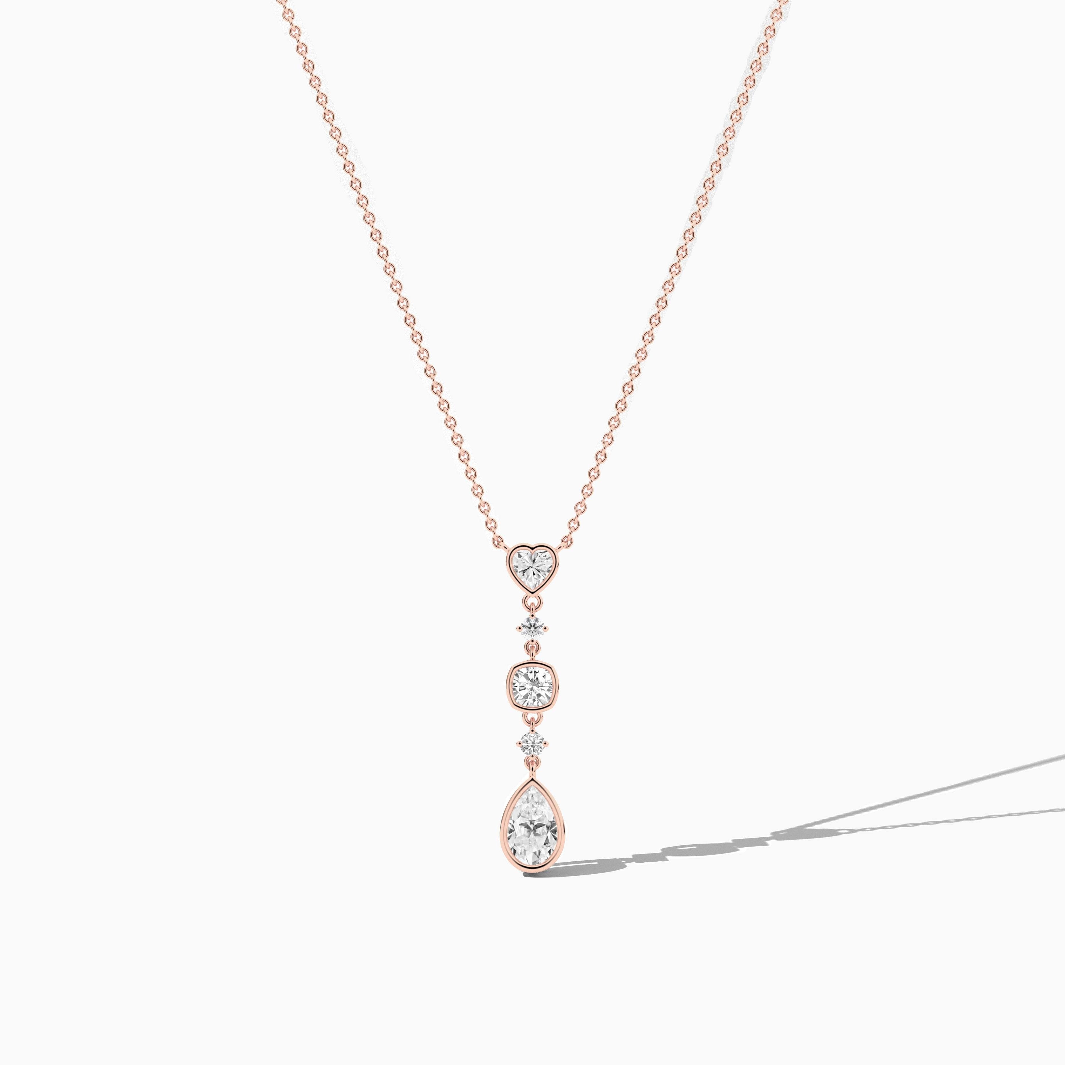 rose gold diamond necklace with heart and pear diamond