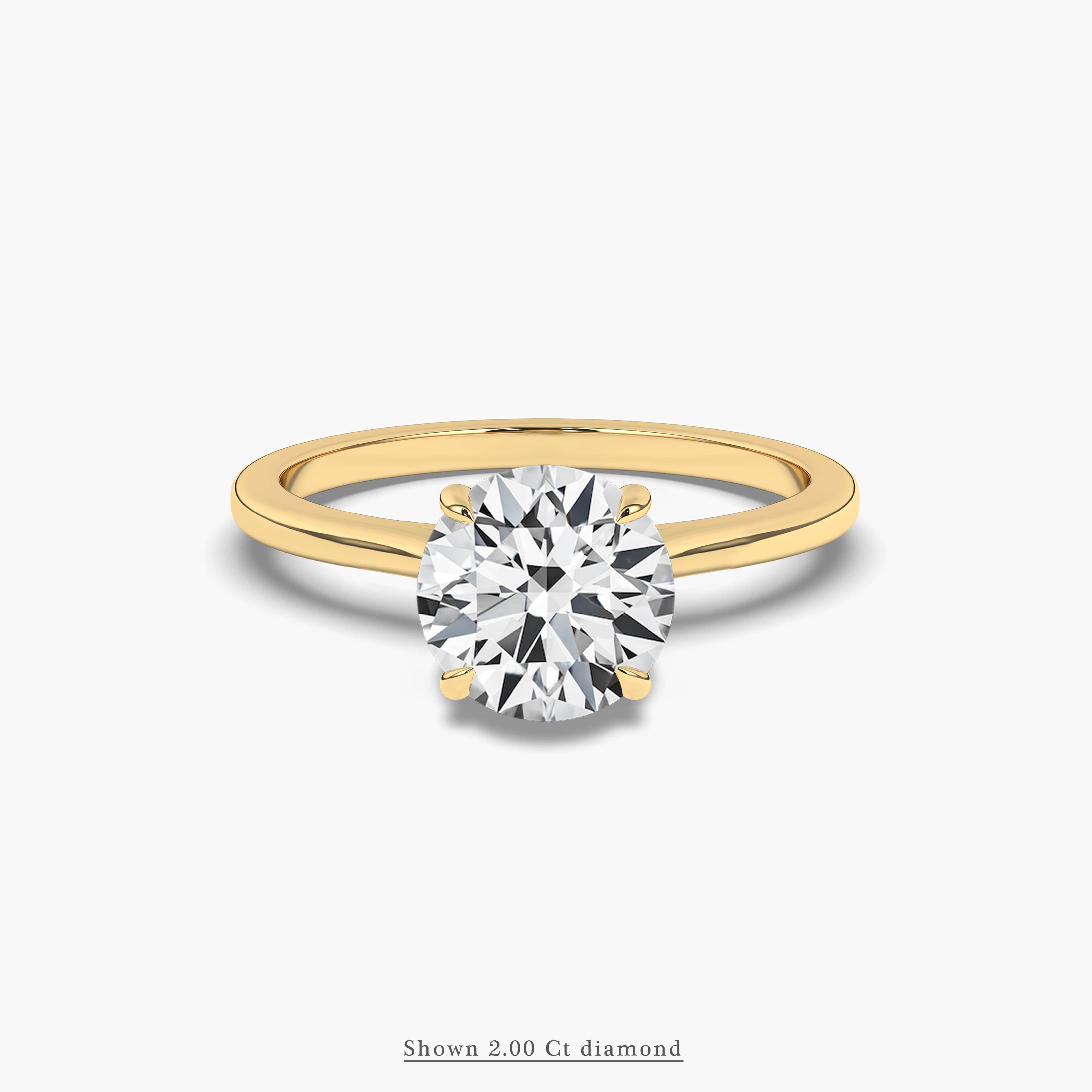 Round diamond solitaire engagement ring set in yellow gold 