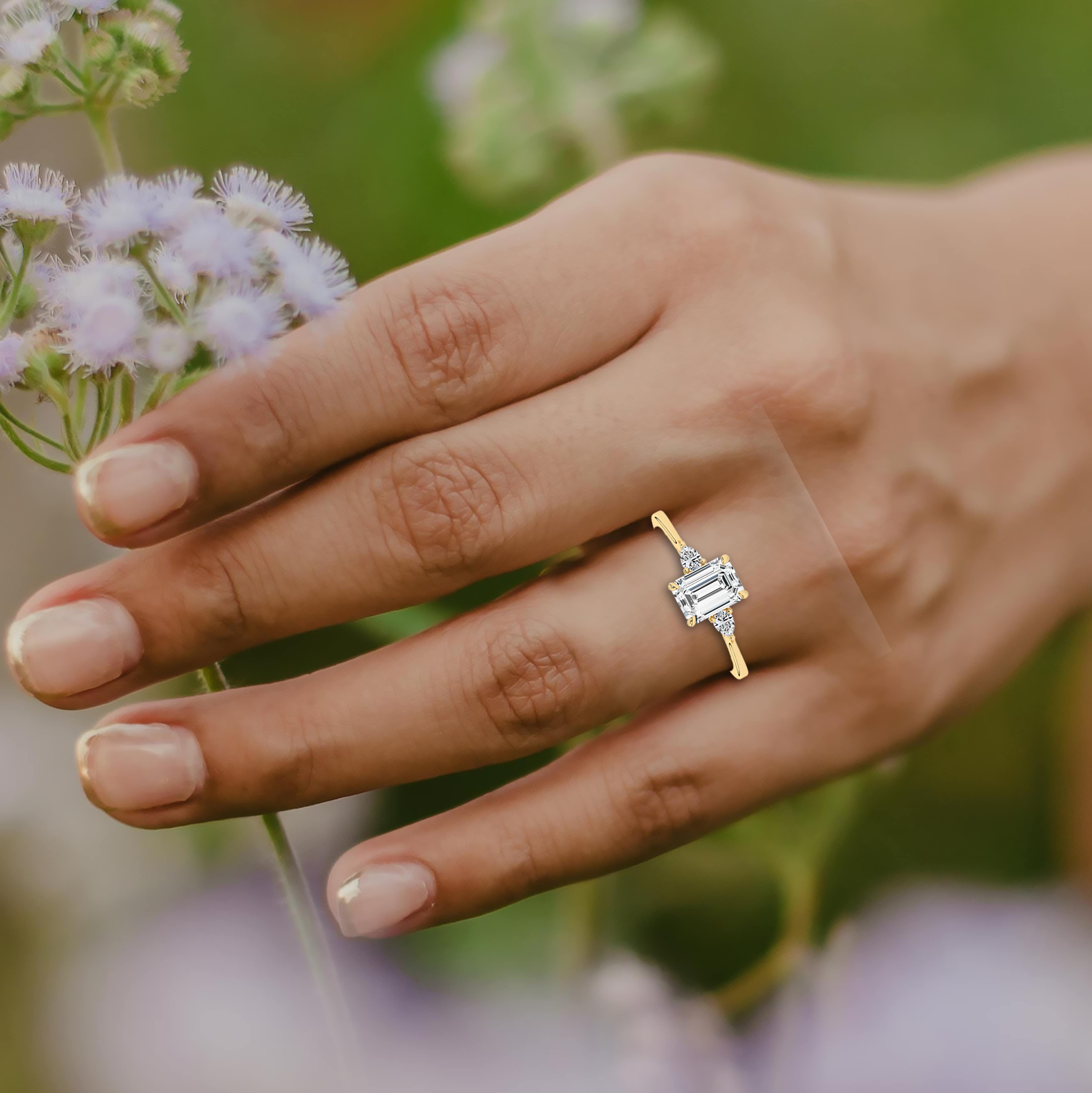 Emerald cut side stones diamond engagement ring 